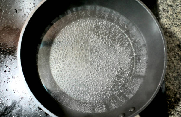 Bubbles in hot water, Boil water with pan stock photo