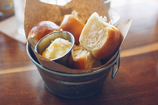 Bucket of pull-apart pav butter buns Bucket of pull-apart pav butter buns bun bread stock pictures, royalty-free photos & images