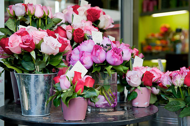 Buckets of fresh pink and red roses outside a florist shop stock photo