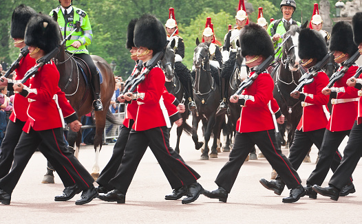 LONDON, UNITED KINGDOM â JULY 11, 2012: The band of the Grenadier Guards, led by a Drum Major of the Coldstream Guards, marches past the front of Buckingham Palace during the Changing of the Guard ceremony.