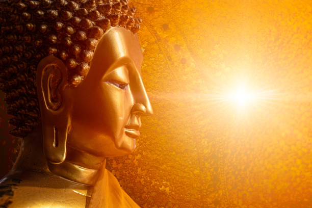 Buddha face head looking at wisdom light calm peace to nirvana way of life in Asian religion concept. stock photo