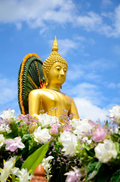 Buddha statue on bright sky background. stock photo
