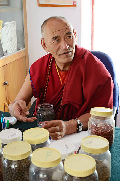 Buddhist pharmacist Leh, Ladakh, India - September, 13, 2012: Buddhist monk pharmacist in tibetan monastery Thiksey Gompa in Ladakh, India. tibetan ethnicity stock pictures, royalty-free photos & images