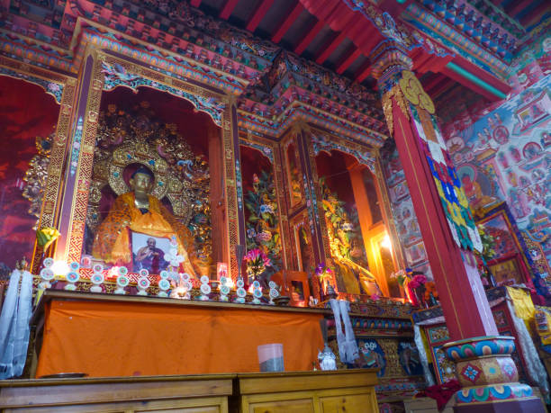 Buddhist Temple in Upper Pisang, Nepal Upper Pisang, Nepal, september 10, 2015: Statue of Buddha in the Buddhist Temple surrounded by colorful walls gompa stock pictures, royalty-free photos & images