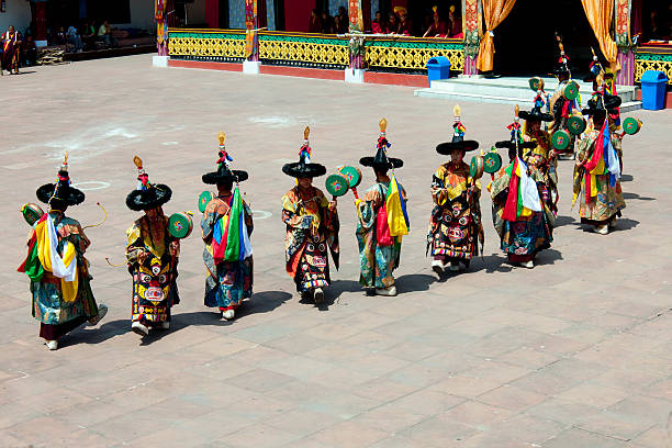 Buddhist Traditional Dancers in Rumtek Monastery Sikkim "Gangtok, Sikkim, India - May 31st, 2012: Tibetan Buddhist monks dancing and playing during annual religious ceremony in Rumtek Monastery(Kagyu order) near Gangtok; North East India." gompa stock pictures, royalty-free photos & images