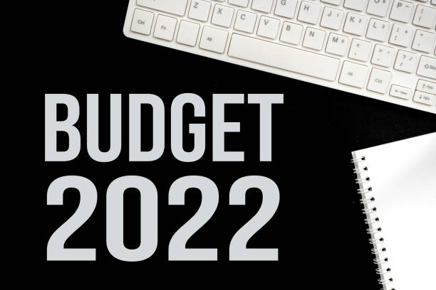 budget 2022 over black background with white computer keyboard stock photo