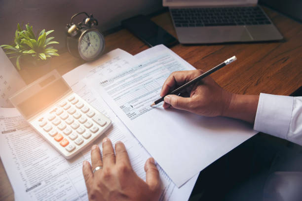 Budget planning concept Budget planning concept,Accountant is calculating company's annual tax.Calendar 2020 and personal income tax forms for those who have income under US law placed on office desk.This is the season to pay taxes. tax stock pictures, royalty-free photos & images