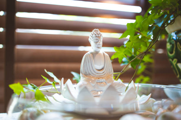Budha Prayer Small statue of Budha with an English ivy in the background buddha statue home decor stock pictures, royalty-free photos & images