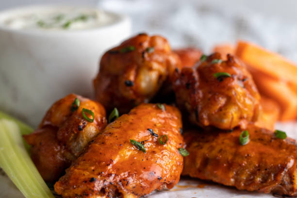 Buffalo chiken wings with bbq sauce and celery stock photo