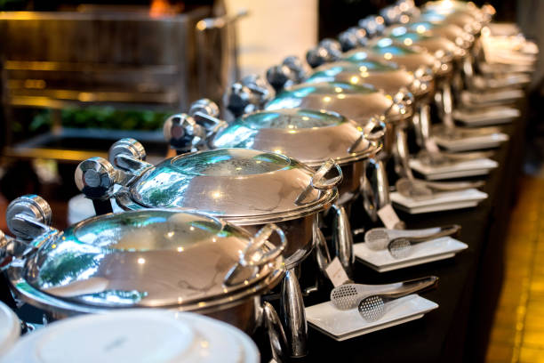 Buffet Table with Row of Food Service Steam Pans stock photo
