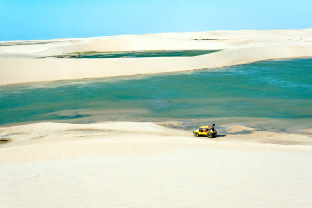 Buggy with tourists traveling through the desert Jericoacoara National Park, Ceara state, Brazil stock photo