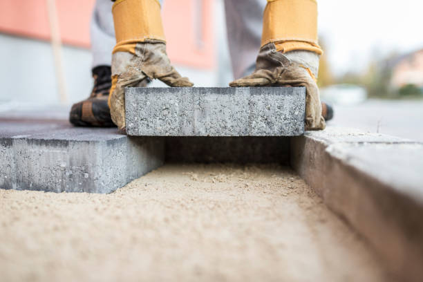 Builder laying outdoor paving slabs stock photo