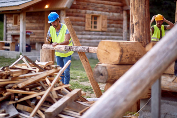 Builders making a wooden cottage in the forest. Construction, building, workers stock photo