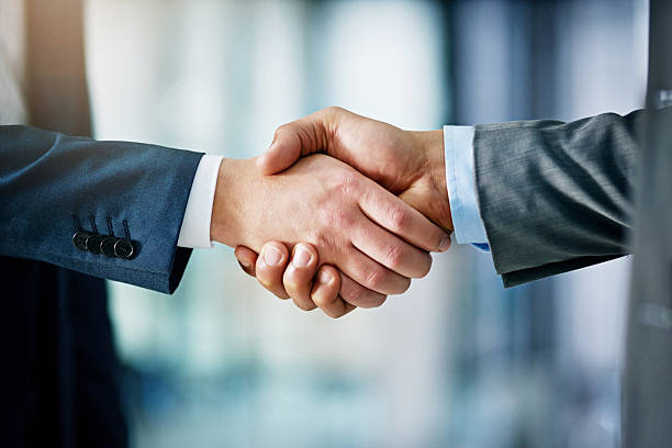 Building a network towards success Closeup shot of two businessmen shaking hands in an office business handshake stock pictures, royalty-free photos & images