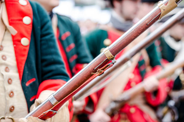 Building musketeers with guns. Focus on the gun Building musketeers with guns. Focus on gun historical reenactment stock pictures, royalty-free photos & images
