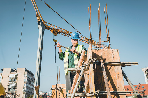 Building Worker Is Working At The Rooftop At The Construction Site Stock  Photo - Download Image Now - iStock