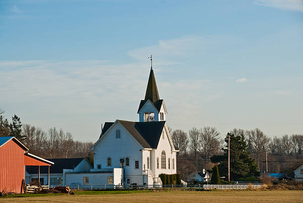Historic White Church and Red Barn Conway, Washington, USA - February 09, 2011: Built in 1916, Fir Conway Lutheran Church is one of the most beautiful churches in the Pacific Northwest. Inside the church, there's a lovely sanctuary and one of the finest pipe organs in the area. jeff goulden barn stock pictures, royalty-free photos & images
