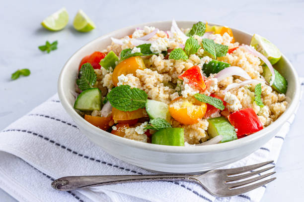 Bulgur Wheat Salad with Vegetables on White Background Close-Up stock photo