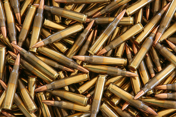 Bulk 5.56 x 45mm NATO Ammo "5.56mm Ammunition in bulk, close up." ammunition stock pictures, royalty-free photos & images