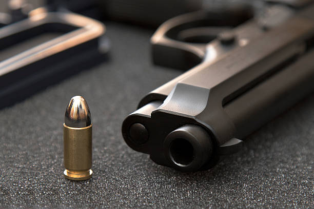Bullet and gun Gun placed in 1 bullet and horizontal gun violence stock pictures, royalty-free photos & images