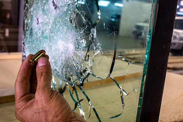 Bulletproof Glass Bulletproof glass with hand and bullet armored clothing stock pictures, royalty-free photos & images