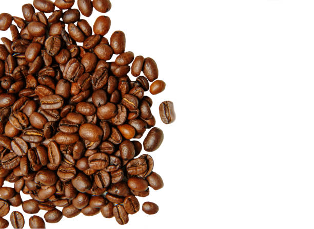 A bunch of coffee beans are lying on a white background. Isolate. Top view. stock photo