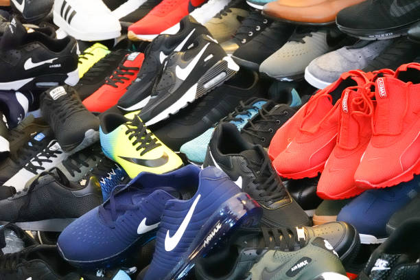 Bunch of fake brand shoes at the bazaar. stock photo