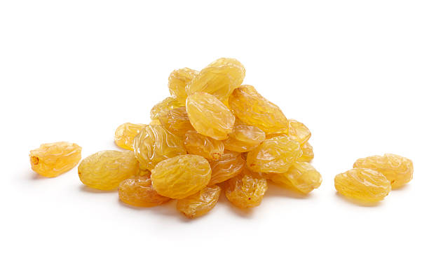 Bunch of golden yellow raisins isolated on white background heap of raisins isolated on white background raisins stock pictures, royalty-free photos & images