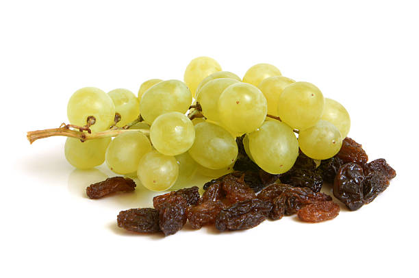 Bunch of grapes and raisins stock photo