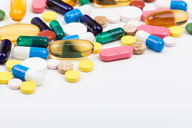 Bunch of pills and capsules on white stock photo