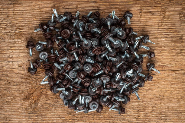 bunch of self-tapping screws for fixing the roof with brown hex heads. stock photo