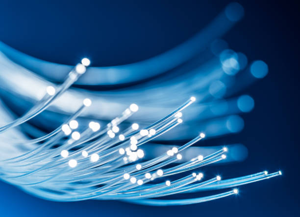 bundle of optical fibers with lights in the ends. - fibra imagens e fotografias de stock