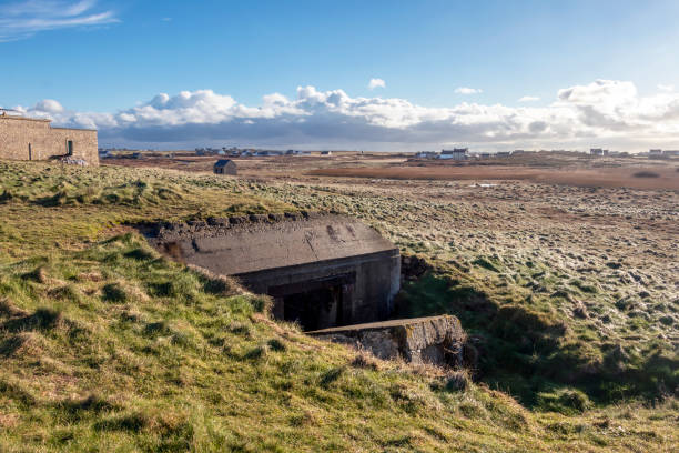 Bunker from world war 2 in a green meadow Ouessant Island - Finistere, Brittany, France Bunker from world war 2 in a green meadow Ouessant Island - Finistere, Brittany, France, Europe bomb shelter stock pictures, royalty-free photos & images