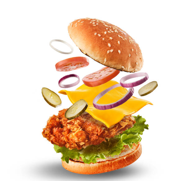 Burger with flying ingredients. Delicious monster Hamburger cheeseburger explosion concept flying ingredients stock photo