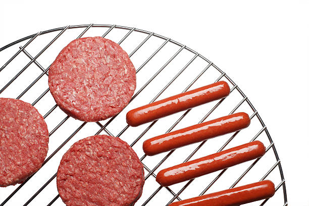 Burgers and Hot Dogs on Grill stock photo
