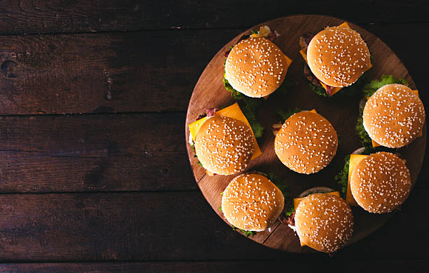 Burgers on the wooden background stock photo