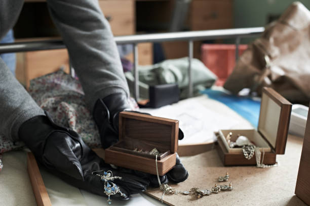Burglar Stealing Items From Bedroom During House Break In stock photo