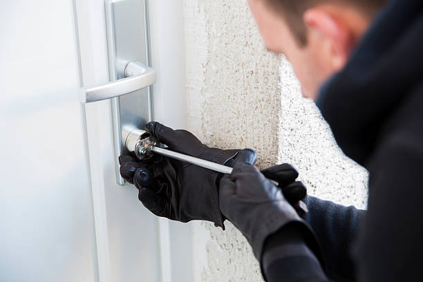 Burglar using special tools to break in  a house stock photo