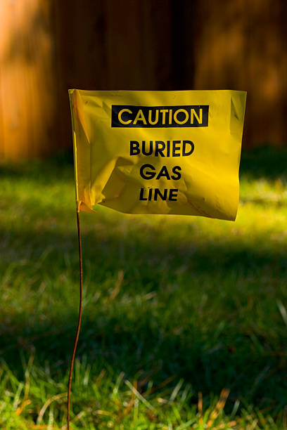 CAUTION - Buried Gas Line flag yellow flag cautioning against digging because of an underground gas line buried stock pictures, royalty-free photos & images