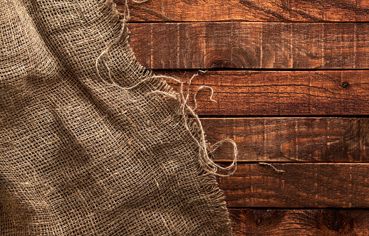 Burlap texture on wooden table background. Wooden table with sacking