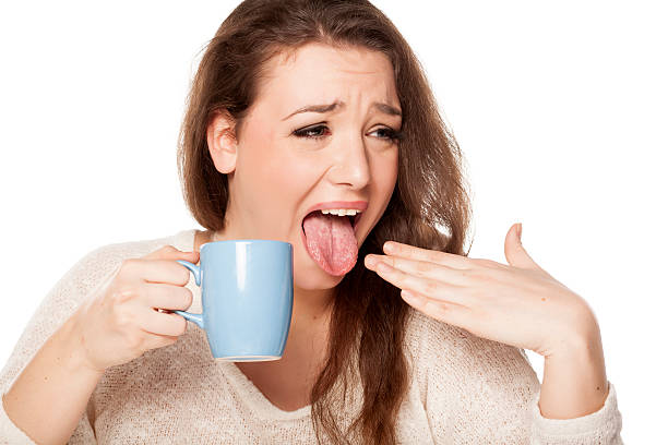 burned tongue young woman with burned tongue from her hot tea sour taste stock pictures, royalty-free photos & images