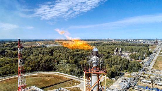 A burner for burning associated gas at a petrochemical plant. Aerial view.