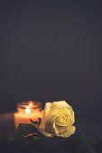 istock Burning Candle and White Rose for Rememberance 1344696112