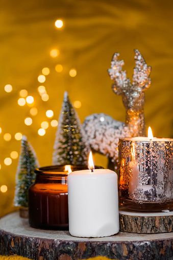 The concept of home comfort during the winter holidays. Candles in the house. Decor and warmth.