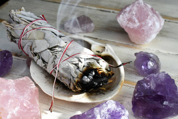 Burning Sage Smudge Stick A close up image of a burning white sage smudge stick used for energy clearing and healing. sage stock pictures, royalty-free photos & images