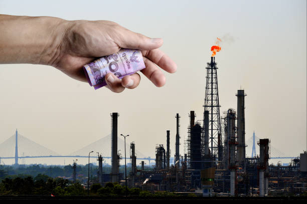Burning Thai Baht on fossil fuel stock photo