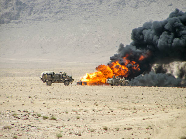 Burning vehicle in Afghanistan War Military vehicles inspecting destroyed vehicle afghanistan stock pictures, royalty-free photos & images