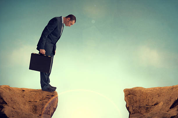 businesman facing a challenge businessman nervously facing an obstacle challenge cliffs stock pictures, royalty-free photos & images