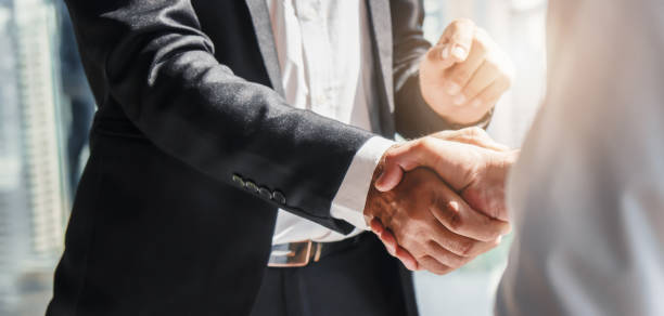 business background of businessman having handshake business background of businessman having handshake handshake stock pictures, royalty-free photos & images