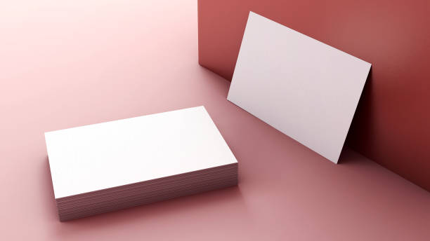Business cards mockup in a pile and resting on a wall. Minimal branding and stationery design concept. Blank visit card to insert design stock photo
